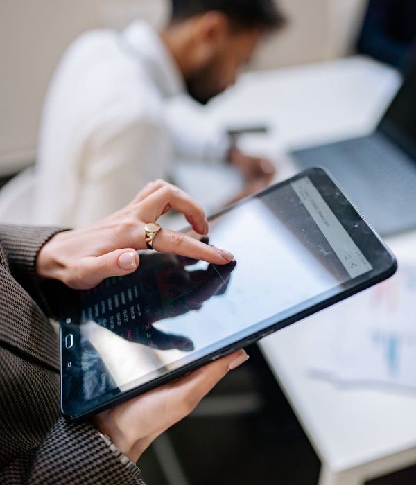 man holding tablet in contemporary workspace